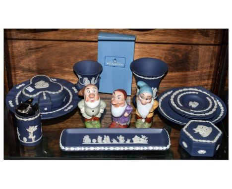 Three Walt Disney porcelain match/spill holders modelled as three of the seven dwarves, stamped beneath Genuine Walt Disney C