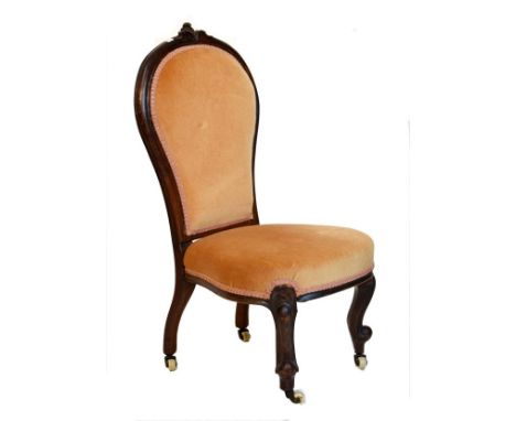 Victorian walnut framed nursing chair with padded back and seat on cabriole front supports and ceramic castors   Condition: 