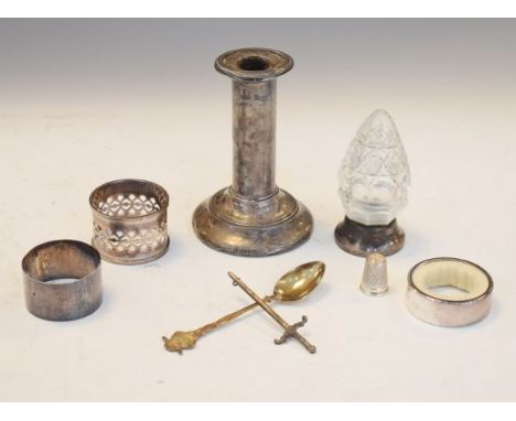 Silver candlestick, cut glass scent bottle with silver cover, napkin rings etc   Condition: 