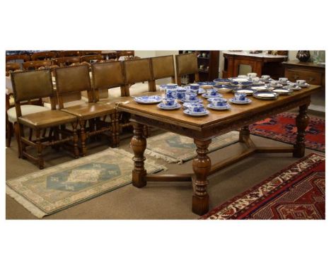 Good quality reproduction Jacobean style distressed oak nine piece dining suite comprising rectangular topped drawleaf refect