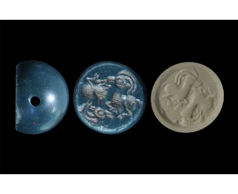3rd-7th century AD. A carved agate seal matrix with intaglio design of a two crouching ibexes; supplied with a museum-quality