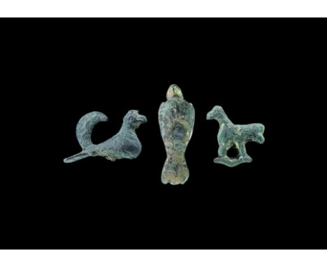12th-14th century AD. A group of bronze bird mounts comprising: one gilded dove(?) with wings crossed, feather decoration on 