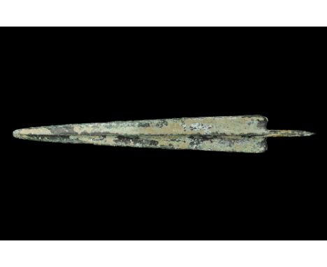 14th-10th century BC. A large triangular Bronze Age spearhead with rounded tip, median ridge and round-section tang, rounded 