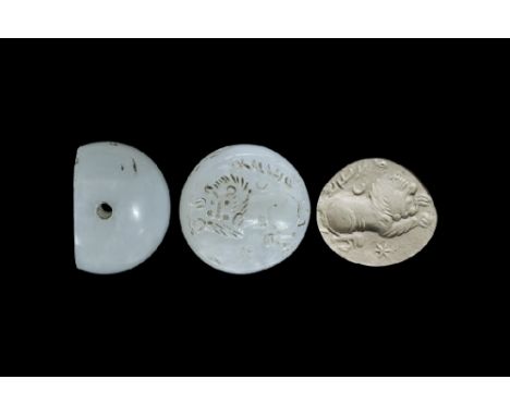 3rd-7th century AD. A carved agate seal matrix with intaglio design of a crouching lion flanked by crescent moon and star, te