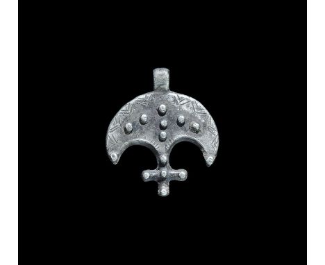 11th-13th century AD. A crescentic silver plaque with integral loop, incised chevrons and applied granules, median cross to t