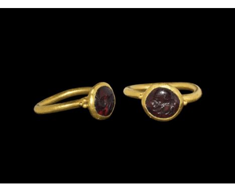 1st-3rd century AD. A gold ring with thick rounded shank with a small rounded bezel, beads of gold at the point where the sha