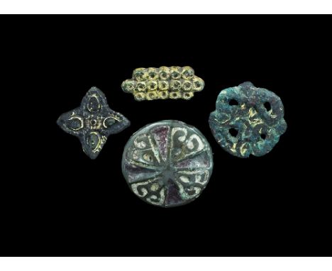9th-12th century AD. A mixed group of mounts comprising: a rectangular plaque of annulets, two studs to the reverse; a domed 