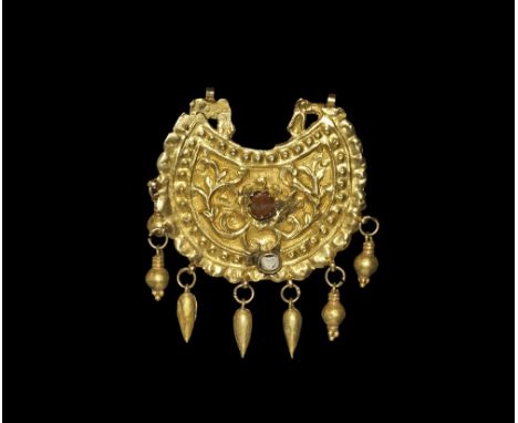 16th-early 18th century AD. A crescentic gold pendant with inner panel of repoussé tendrils, beaded border and dentilled edge