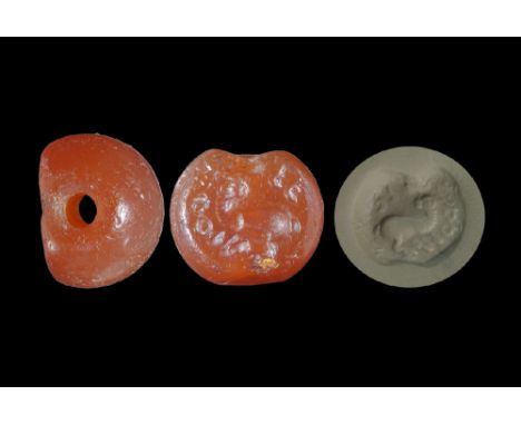 3rd-7th century AD. A carved carnelian seal matrix with intaglio design of a ram with Pahlavi text around; supplied with a mu