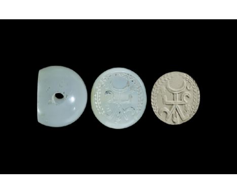 3rd-7th century AD. A carved agate seal matrix with intaglio design of a battle standard with star and crescent, wreath aroun