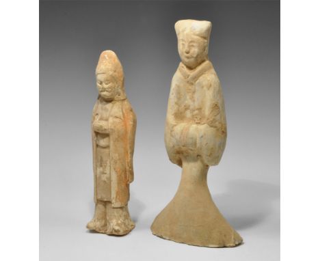 Tang Dynasty, 618-906 AD. A group of two ceramic figurines comprising: a slender figure in a bell-shaped tunic and cap, the h