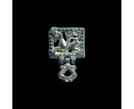 10th-11th century AD. A gilt-bronze rectangular plaque with beaded border and openwork dragon motif; articulated loop to the 