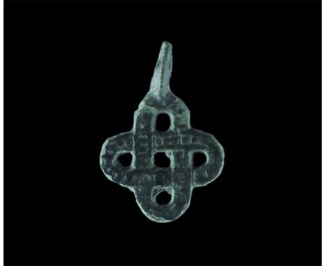 11th-12th century AD. A flat-section bronze pendant with pierced lug above, openwork panel formed as a knot of beaded bands. 