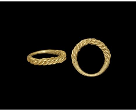 9th-11th century AD. A hoop formed from tightly-plaited regular gold rods, the underside hammer-welded into a single round-se