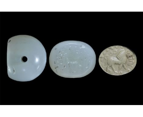 3rd-7th century AD. A carved agate seal matrix with intaglio design of a lion advancing with beaded border and text around; s