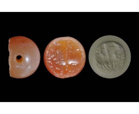 3rd-7th century AD. A carved agate seal matrix with intaglio design of a horseman with foliage; supplied with a museum-qualit