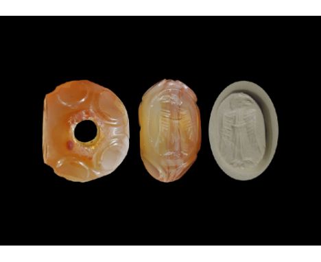 3rd-7th century AD. A carved agate seal matrix with panels to the outer face, intaglio design of a standing bird with wings t