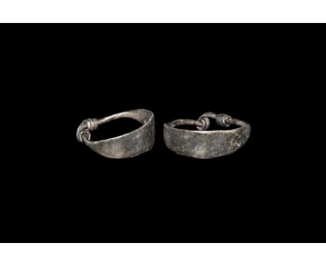 9th-12th century AD. A silver ring with broad flat-section plaque, tapering ends coiled over the shank. 1.92 grams, 21.90mm o