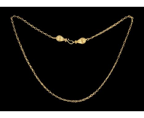 2nd-4th century AD. A short chain of gold links with leaf-shaped plaque to each end, each with beaded filigree bands and gran