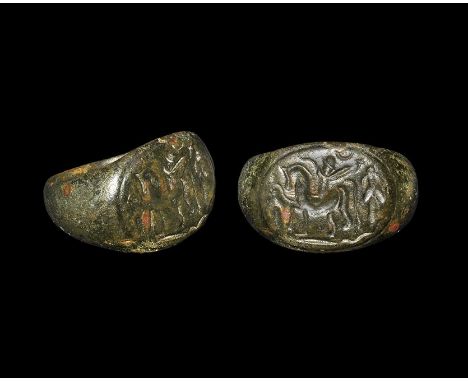 2nd-3rd century AD. A D-section hoop and expanding shoulders, discoid plaque with intaglio scene of a horse and rider amid fo