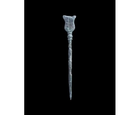11th-14th century AD. A bronze stylus with balustered shaft, collared bulb and heater-shaped finial with incised cross motif 