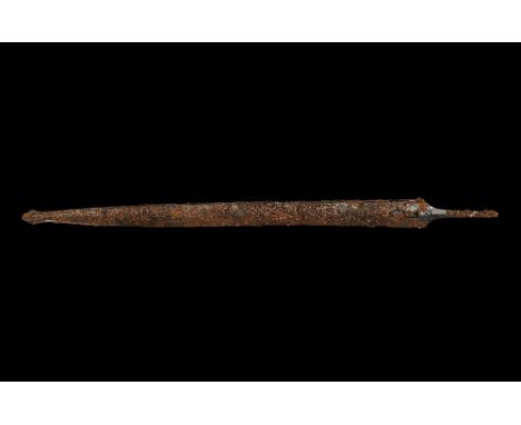 2nd century BC. A slender two-edged iron sword within its iron scabbard; the blade, visible within the open sides of the scab