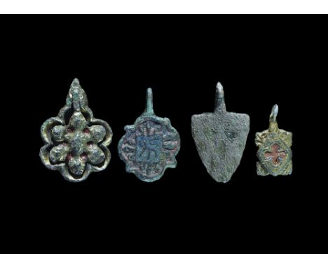 13th-15th century AD. A mixed group comprising: a quatrefoil pendant with red enamel to the lobes, central square with blue e