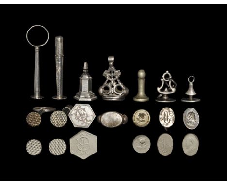 18th-19th century AD. A mixed group of silver seal matrices comprising: a desk wafer seal with tapered shaft and ring handle,