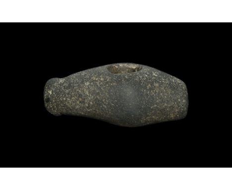 Neolithic, 4th-3rd millennium BC. A ground and polished basalt axe-hammer with tapering hole, one flat striking face and one 