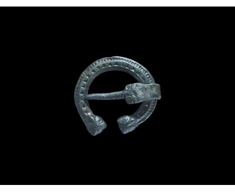 10th-11th century AD. A bronze penannular brooch formed as a C-section shank with punched chevrons to the central band, beadi