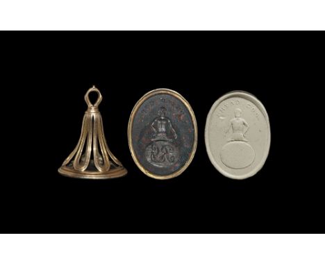 19th century AD. A gold fob seal with openwork mount, the oval green/red bloodstone seal with intaglio crest of a wreathed an