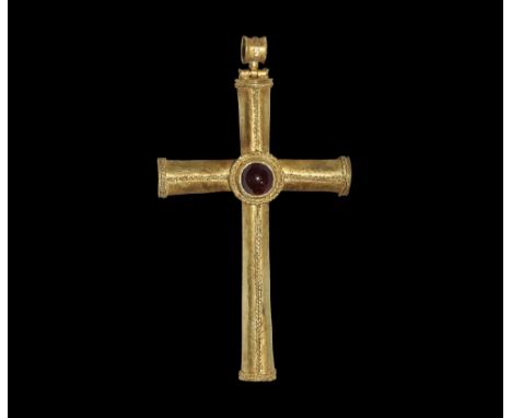 7th century AD. A gold cruciform pendant of four hollow expanding arms with applied filigree ropework fillet to the upper fac
