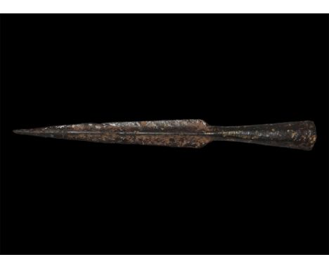 1st-3rd century AD. A hand-forged iron thrusting spearhead comprising a tapering facetted socket with transverse fixing bar e