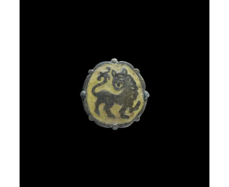 11th-12th century AD. A cast plaque with lobed border and central discoid enamelled panel with reserved motif of a lion in 'p