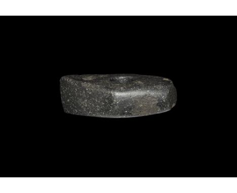 Neolithic, 5th-2nd millennium BC. A pecked and ground axe-hammer with central perforation for hafting, well polished surfaces