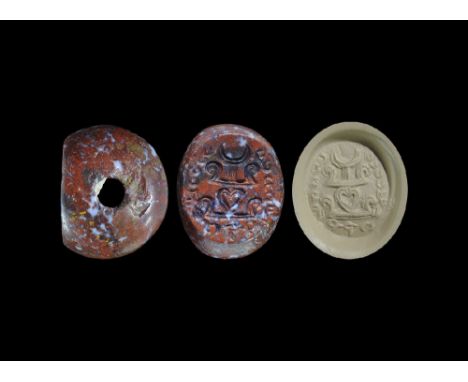 3rd-7th century AD. A carved agate seal matrix with intaglio design of a battle standard with Pahlavi text around; supplied w