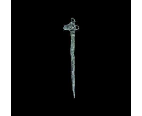 12th-13th century AD. A tapering round-section bronze pin with ribbed fillet and raven-head terminal, two loops for attaching