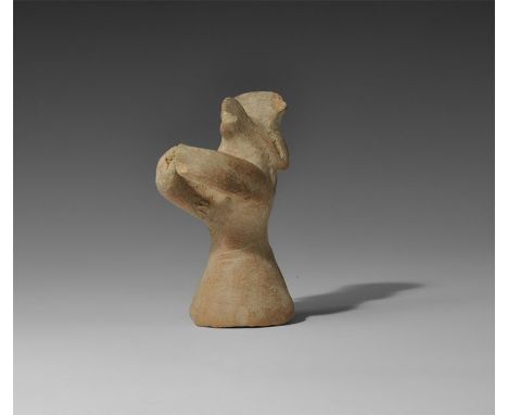 11th-6th century BC. A terracotta figure with conical lower body, flat-section arms extended in a ring, pinched facial featur