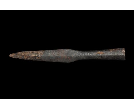 9th-11th century AD. A hand-forged iron spearhead with lozenge-section leaf-shaped blade, broad neck and deep closed socket w