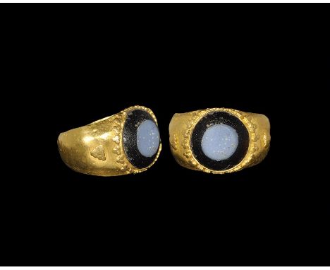 1st-2nd century AD. A D-section gold hoop with expanding shoulders and discoid plaque; triangles of granulation to the should