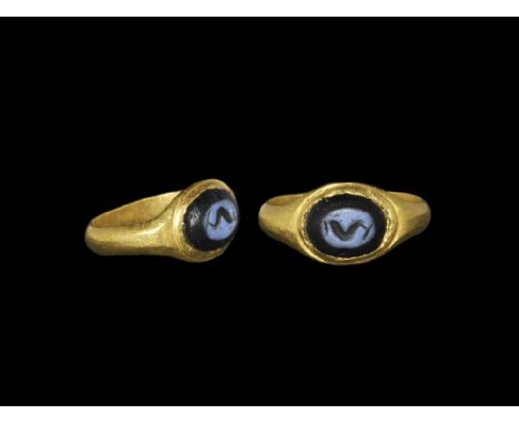 2nd-3rd century AD. A D-section hoop with ovoid plaque, inset nicolo with agate(?) intaglio dolphin motif. 5.98 grams, 22mm o