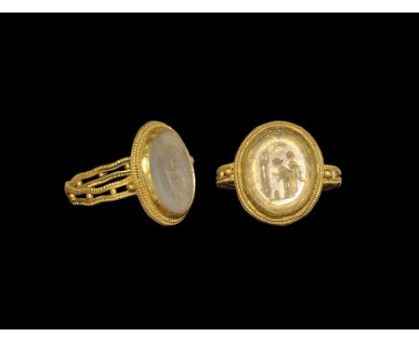 1st-2nd century AD. A gold finger ring in Classical Greek style comprising a hoop formed as parallel wire bands with beaded w