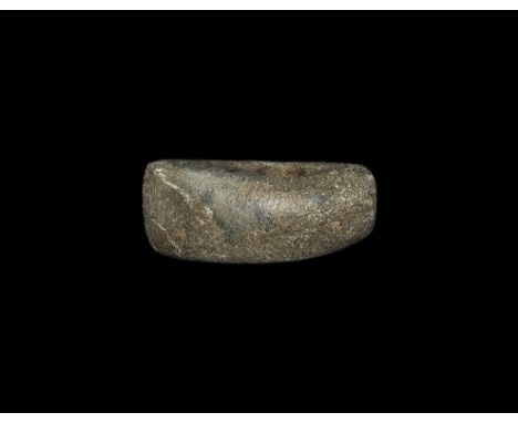 Neolithic, 4th-2nd millennium BC. A pecked and polished stone perforated axe-hammer with boat-shaped profile. 470 grams, 11.6