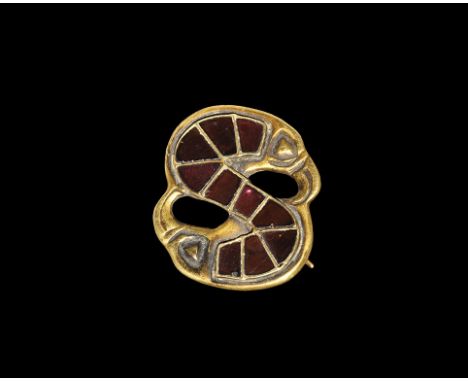 Late 6th-7th century AD. A gold S-brooch with bird-head finials, raised triangular and rectangular cells with inset garnet cl