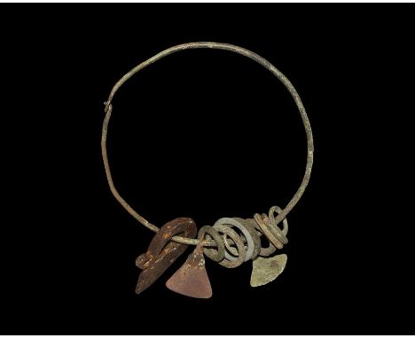 9th-11th century AD. A round-section bronze wire bracelet with hook-and-eye closure, eight round-section bronze rings, a bron
