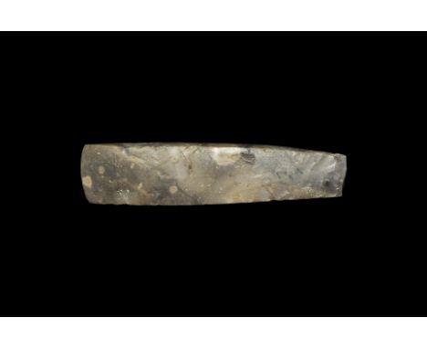 Neolithic, 5th-2nd millennium BC. A large knapped and polished rectangular flint celt with square butt. 325 grams, 19cm (7 1/