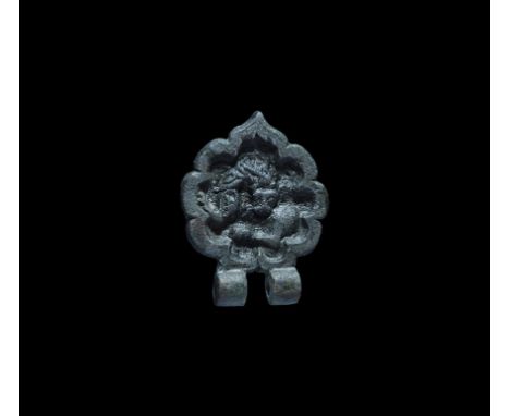 12th-15th century AD. A bronze rosette plaque with raised border, two hinge lugs above, beast biting its own back modelled in
