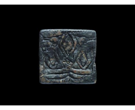 9th-11th century AD. A copper-alloy flat-section square plaque with low-relief design of three eye-shaped panels among tendri
