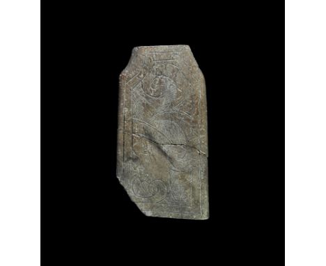 14th-15th century AD. A rectangular bone plaque in two pieces with waisted short edge, decorated with an incised design of a 