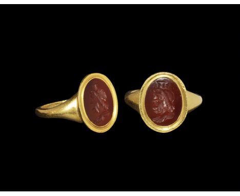 1st-3rd century AD. A carnelian intaglio with Serapis set in a sympathetic modern heavy gold ring. 10.13 grams, 23.1mm overal